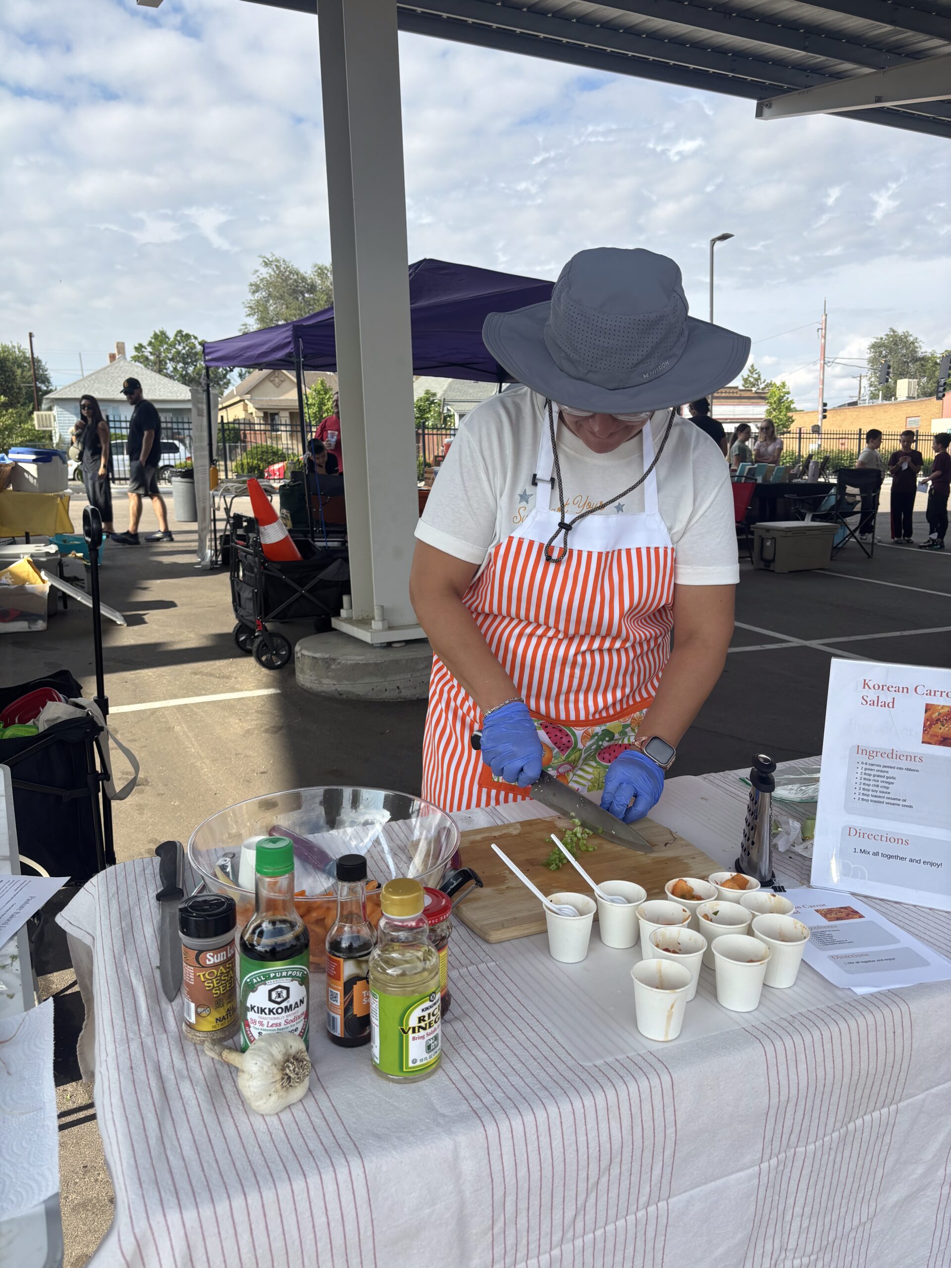 Leah Derrera at the Pueblo's Eastside Market makes Korean carrot salad.