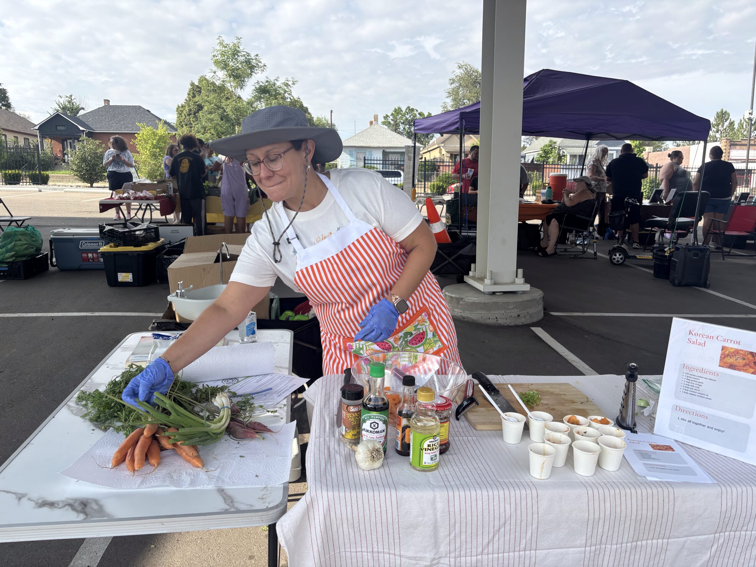 Leah Derrera at the Pueblo's Eastside Market makes Korean carrot salad.