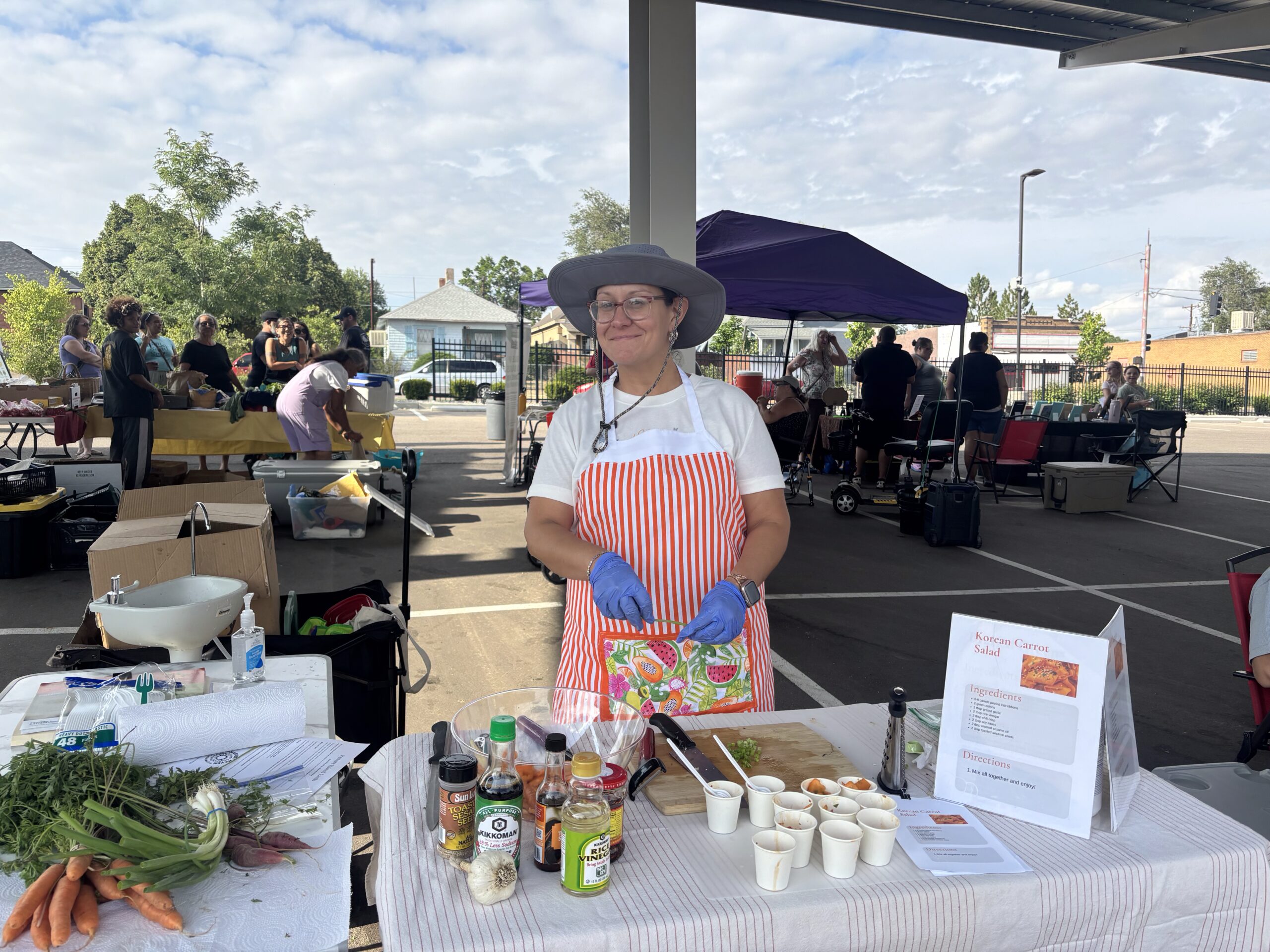 Leah Derrera at the Pueblo's Eastside Market makes Korean carrot salad.
