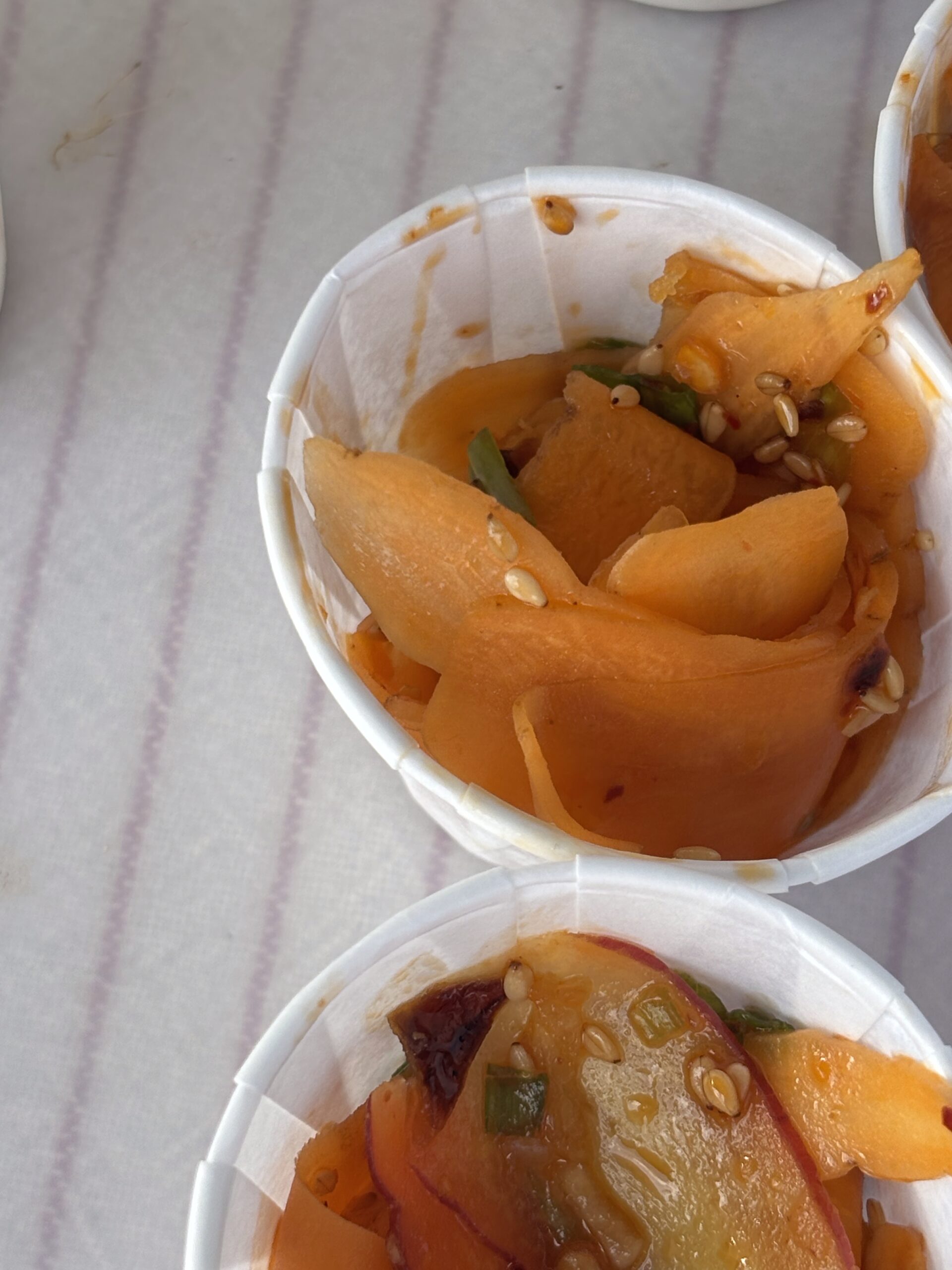 Leah Derrera at the Pueblo's Eastside Market makes Korean carrot salad.