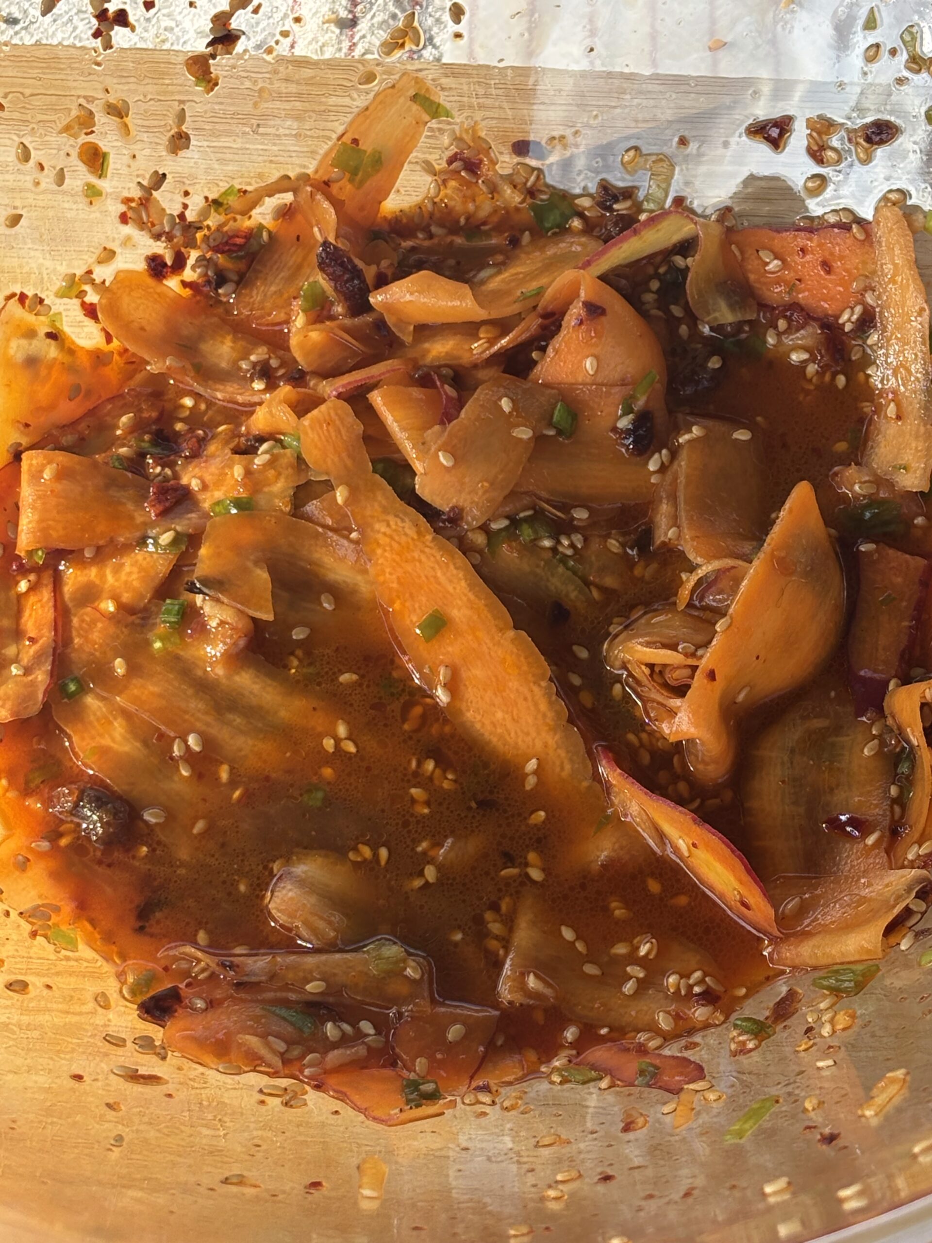 Leah Derrera at the Pueblo's Eastside Market makes Korean carrot salad.